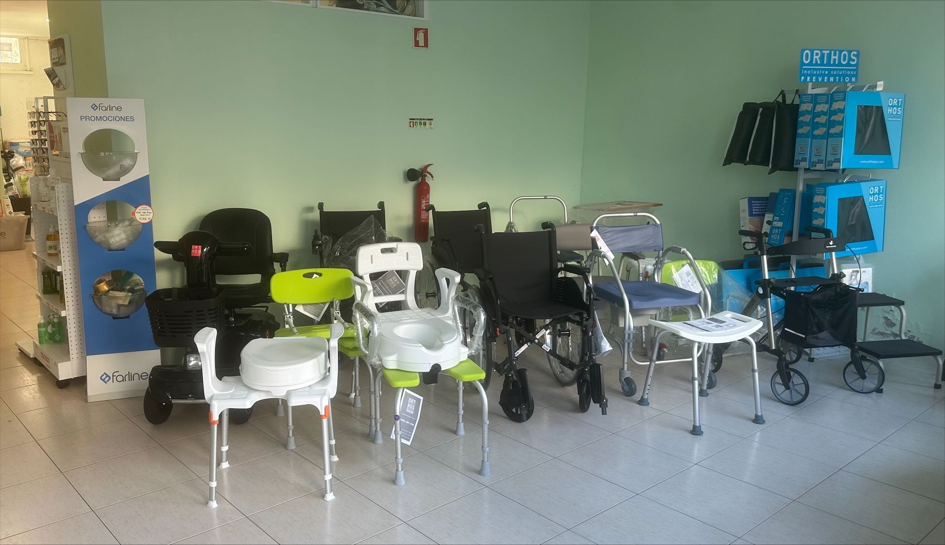 Display of mobility aids and bathroom safety equipment, including wheelchairs and shower chairs in a store.